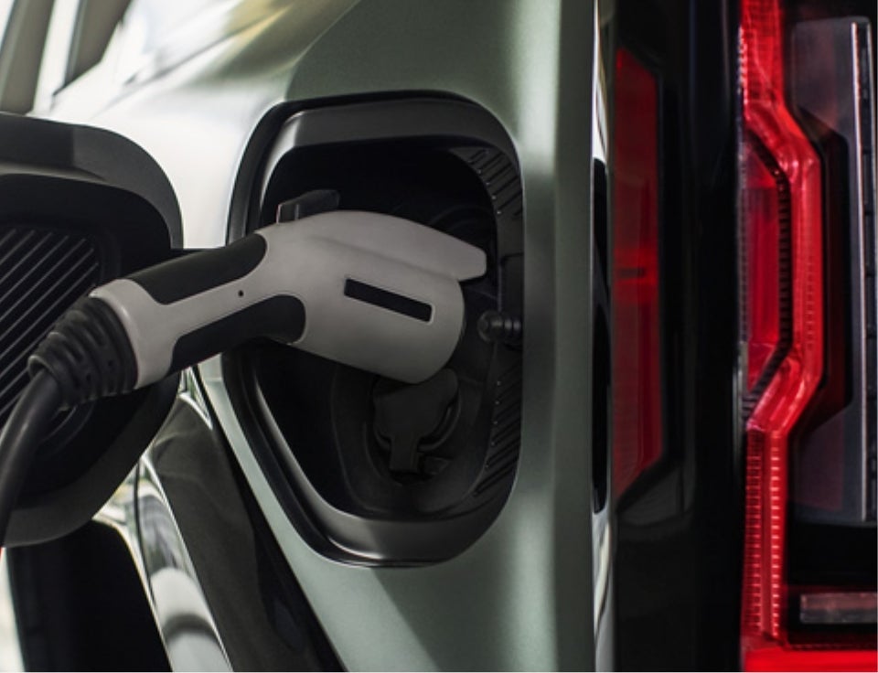Close up of charging port with charger plugged in on a GMC Hummer EV SUV - Franklin GMC in Statesboro GA