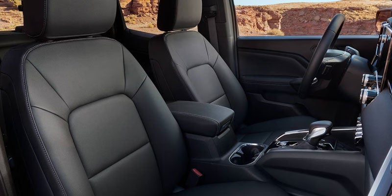 Interior of a vehicle showing black leather front seats, dashboard, and center console.