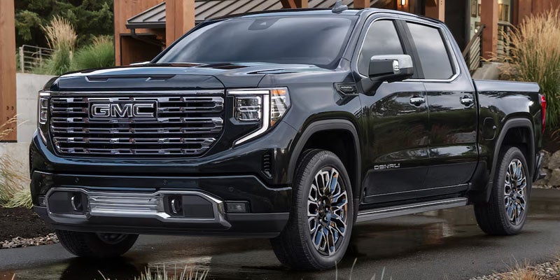 Black GMC Sierra Denali pickup truck parked outdoors.